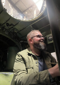 Colour photo of a man in a Lancaster aircraft